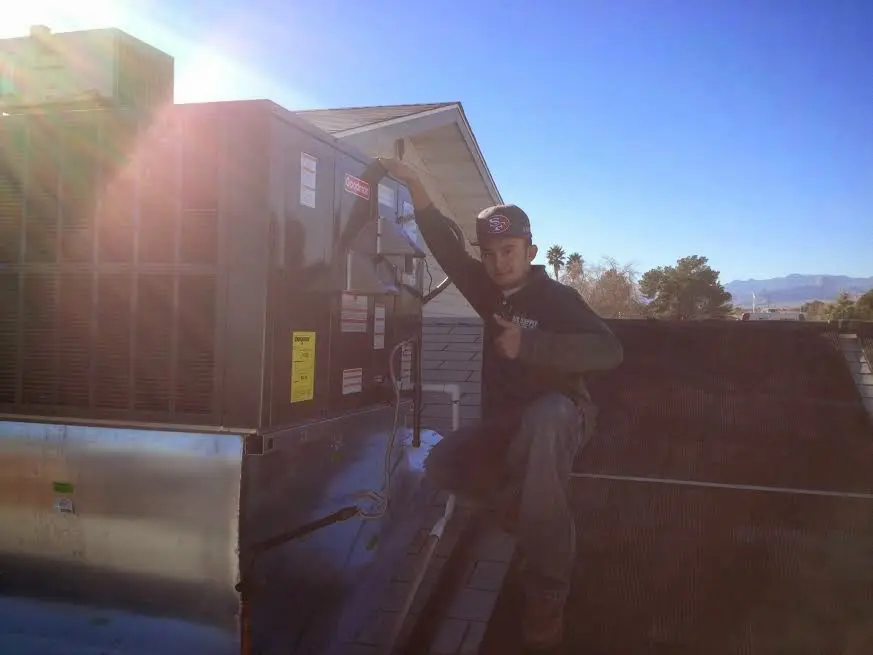 HVAC technician performing HVAC Inspection on a rooftop unit in Garwood